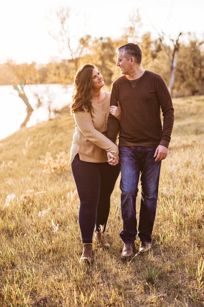 man and woman walking in a field