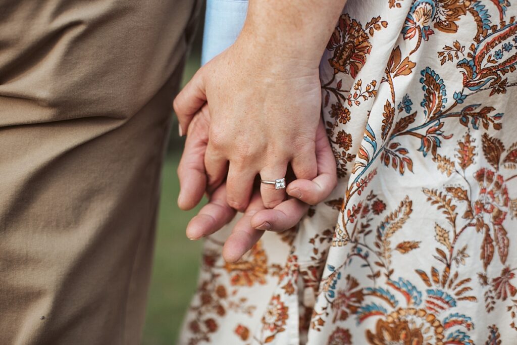 holding hands showing diamond ring