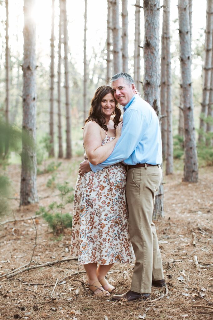 couple posing in the woods